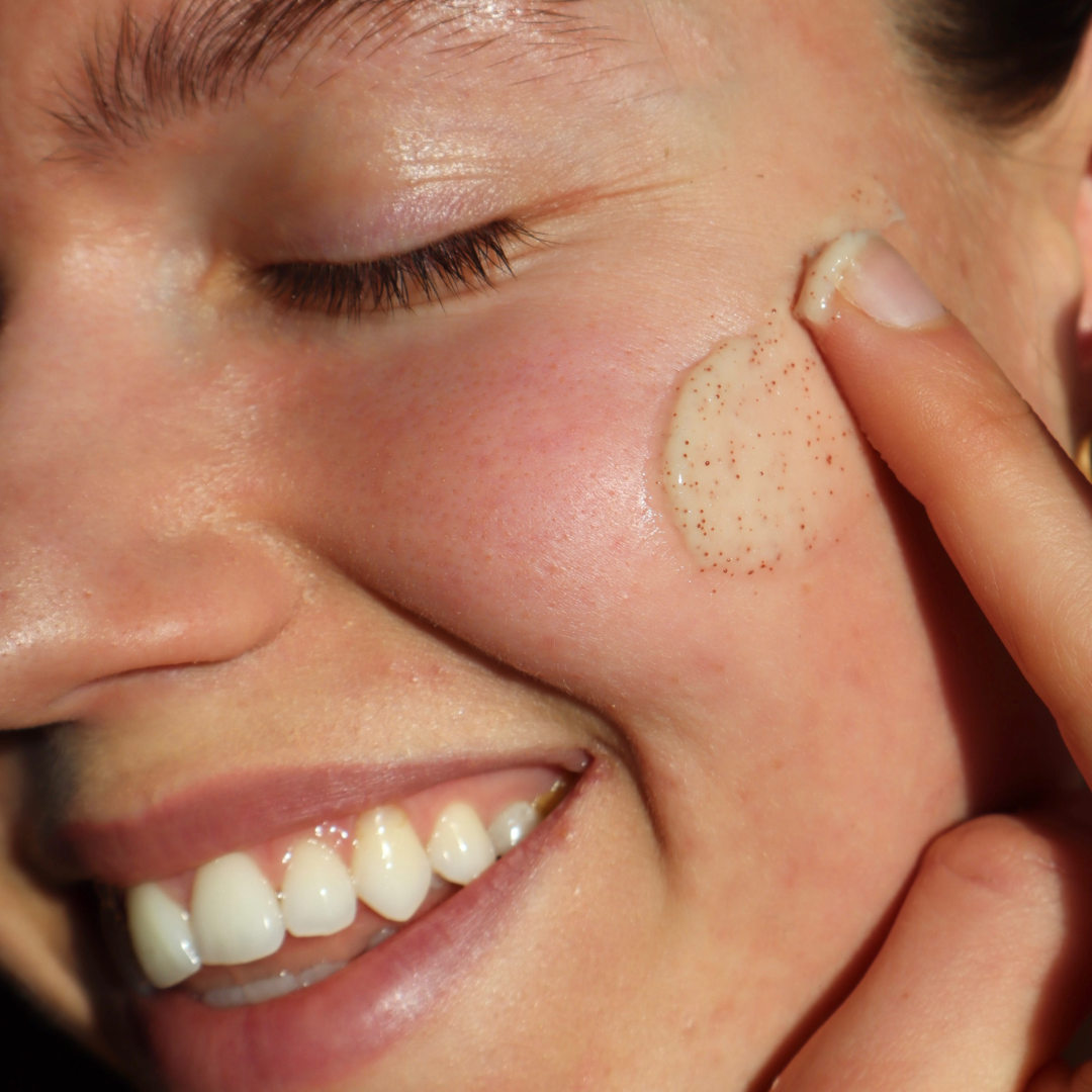 Woman applying HEAR ME RAW Good Clean Fungi quadruple-mushroom cleanser to her face